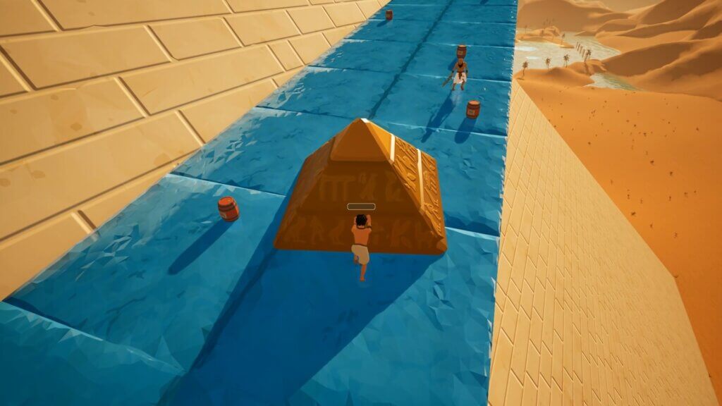 Working together two players are pushing the Pyramidion alongside a waterslide
